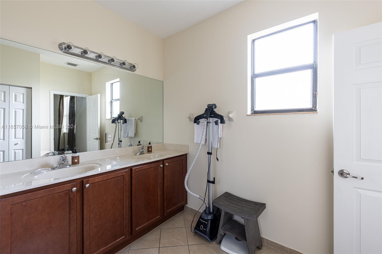 23578 Southwest 113th Path Homestead, FL 33032 - Photo 27 of 59 a bathroom with a sink and a mirror