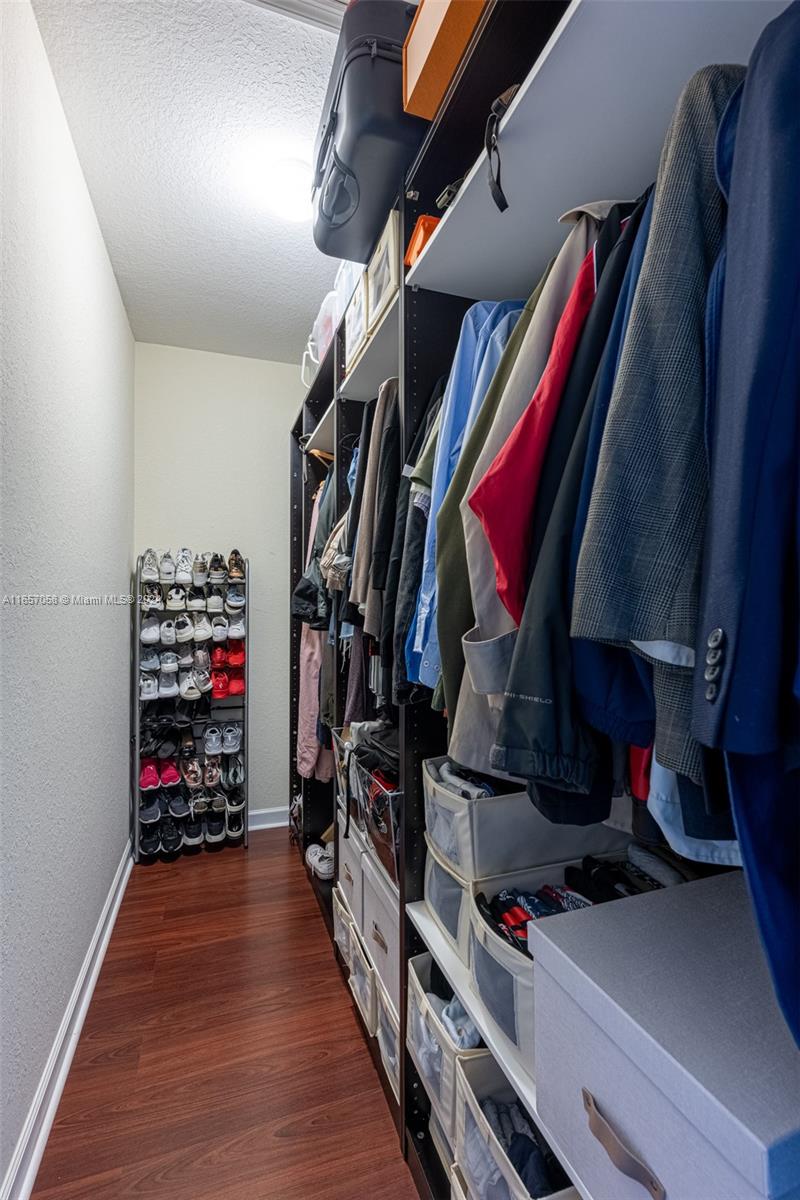 23578 Southwest 113th Path Homestead, FL 33032 - Photo 30 of 59 a view of walk in closet with clothes and shoes