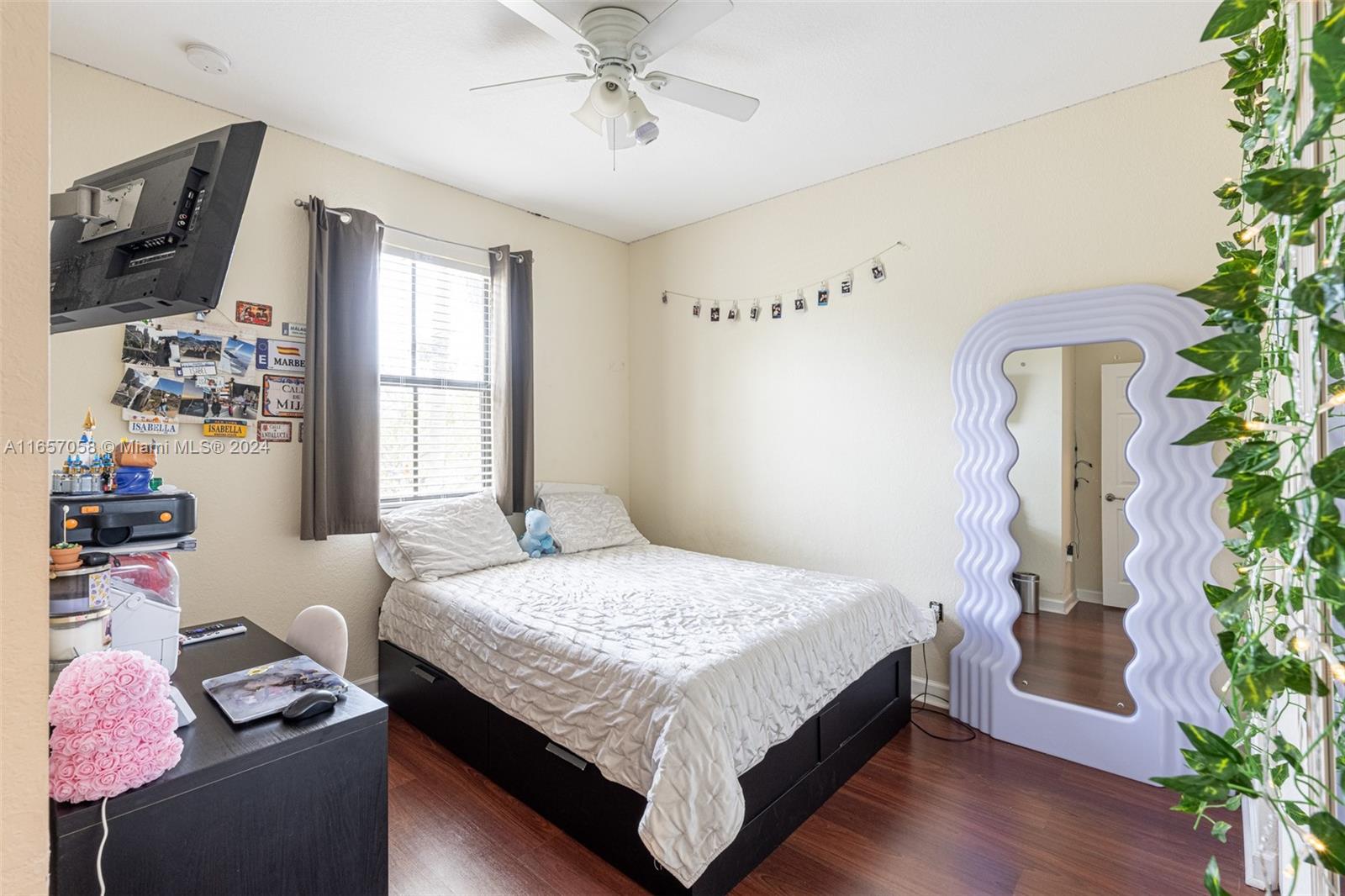 23578 Southwest 113th Path Homestead, FL 33032 - Photo 37 of 59 a bedroom with a bed window and potted plant