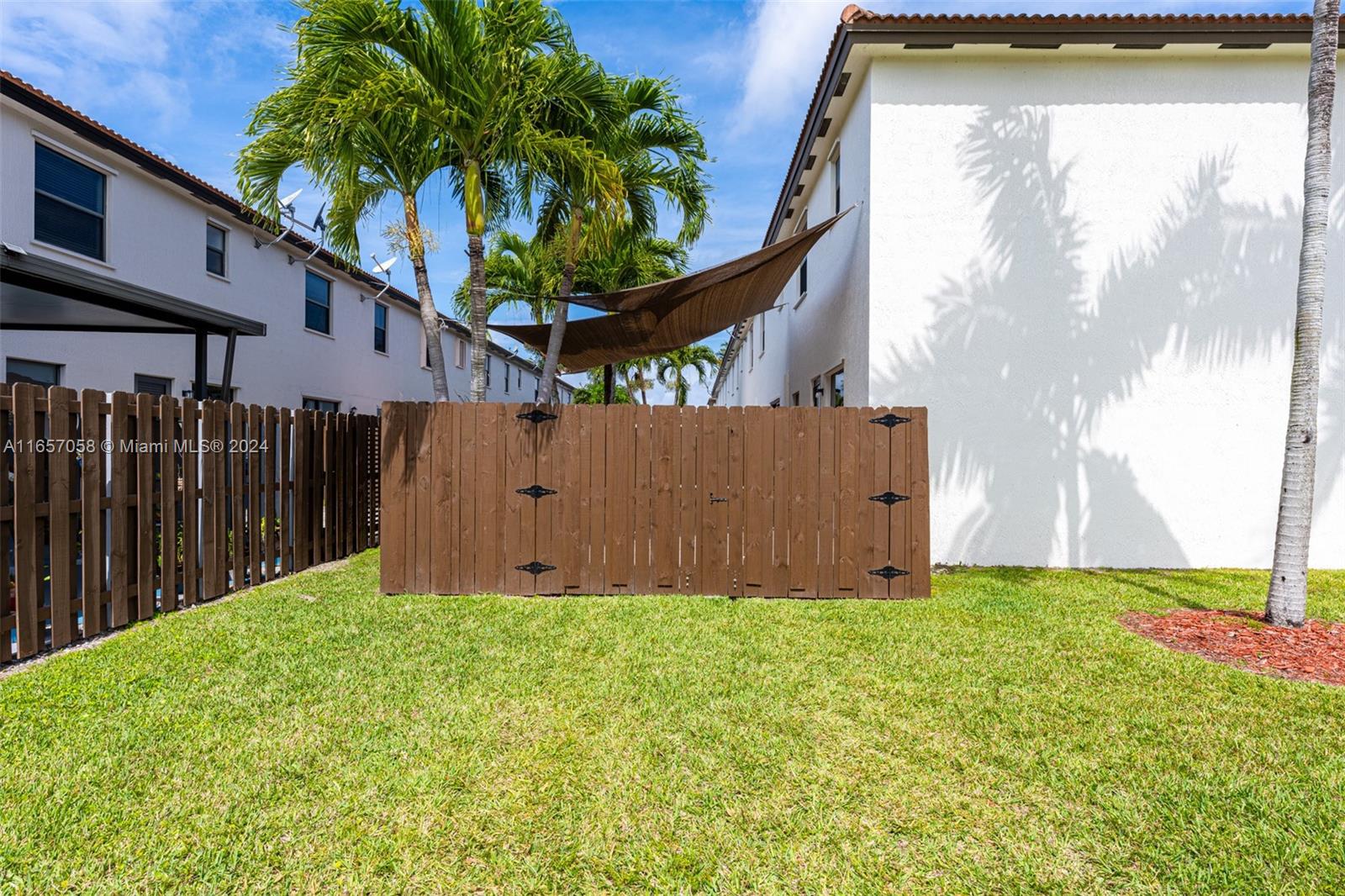 23578 Southwest 113th Path Homestead, FL 33032 - Photo 42 of 59 a view of backyard with small cabin and wooden fence