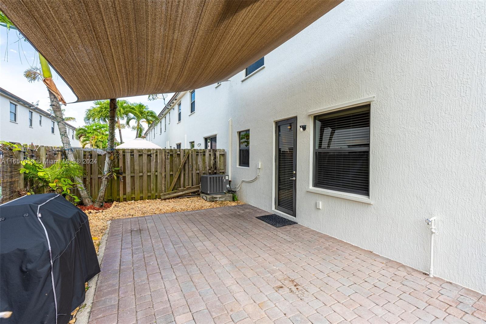 23578 Southwest 113th Path Homestead, FL 33032 - Photo 48 of 59 a view of backyard with wooden fence and large trees