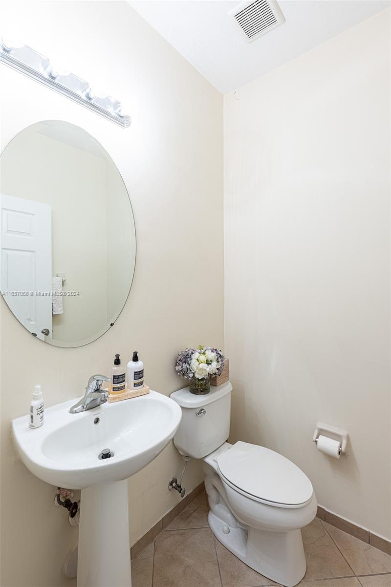 23578 Southwest 113th Path Homestead, FL 33032 - Photo 50 of 59 a bathroom with a sink mirror and toilet