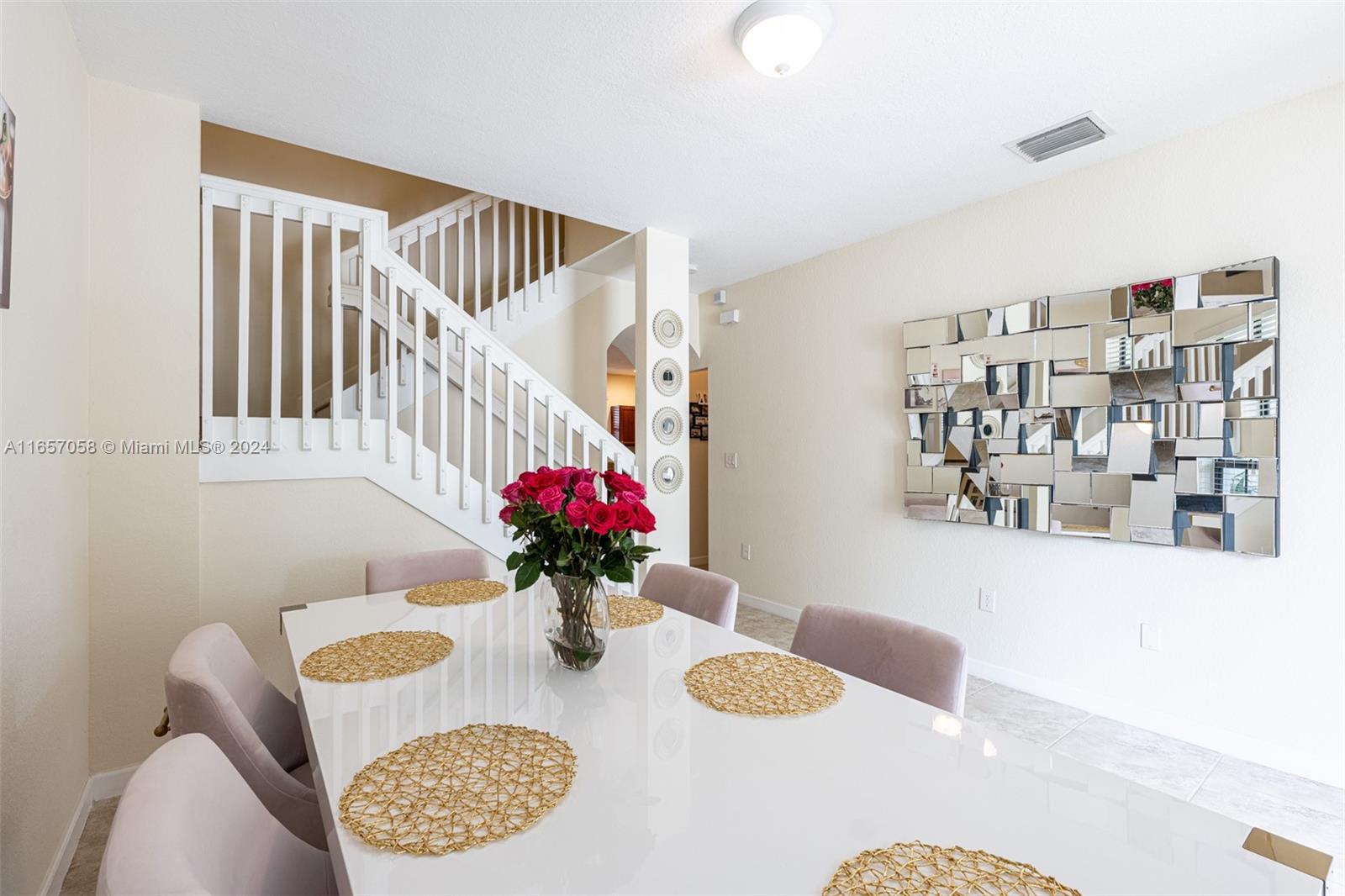 23578 Southwest 113th Path Homestead, FL 33032 - Photo 7 of 59 a dining room with furniture and flowers