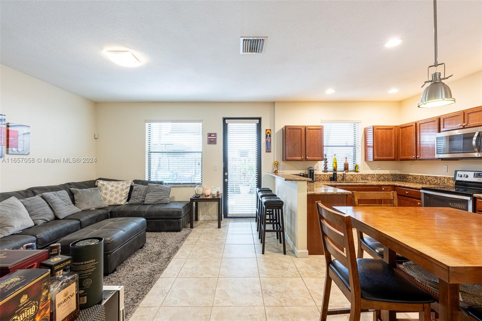 23578 Southwest 113th Path Homestead, FL 33032 - Photo 10 of 59 a living room with stainless steel appliances furniture a rug and a view of kitchen