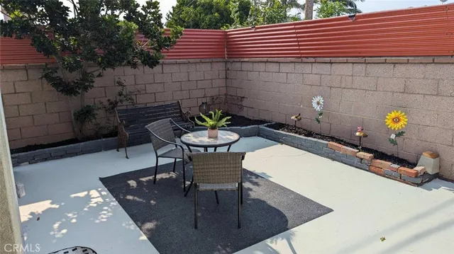 a backyard of a house with table and chairs