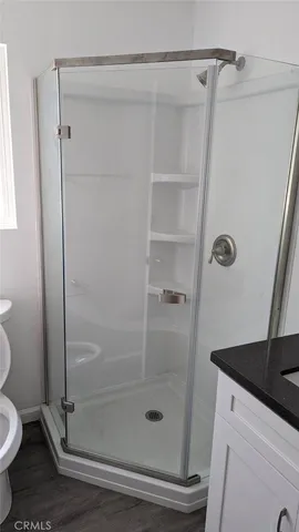 a bathroom with a shower a toilet and sink