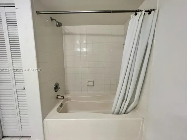 a bathroom with a shower and a bath tub