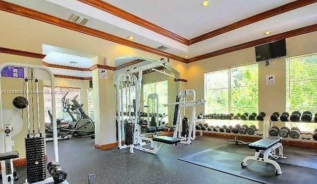 a view of a livingroom with couch and large windows