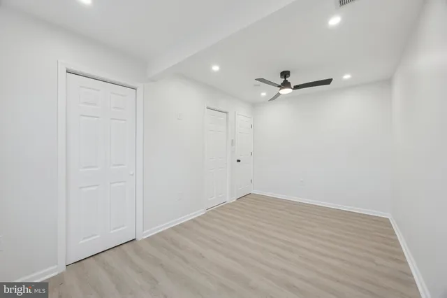 a view of an empty room with a ceiling fan