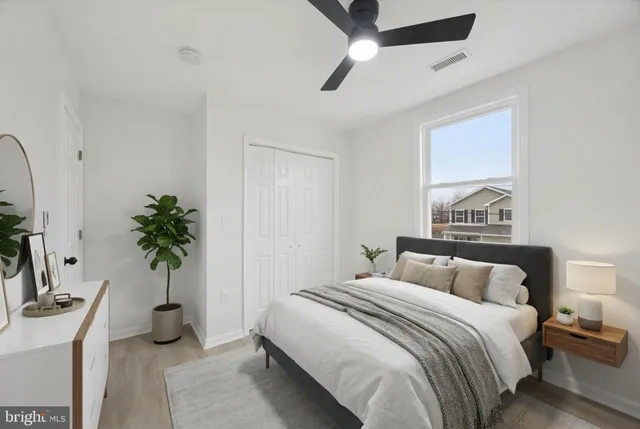 a bedroom with a bed and a potted plant
