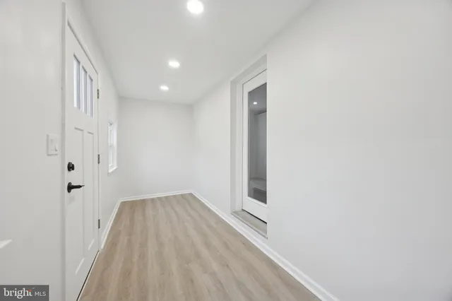 a view of a hallway with wooden floor