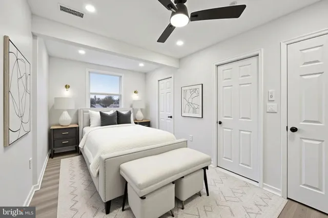 a bed room with a bed and a ceiling fan