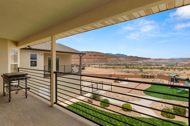 2591 East Washington Dam Road Washington, UT 84780 - Photo 10 of 67 Covered outdoor living space featuring wood-finish flooring and black horizontal railings