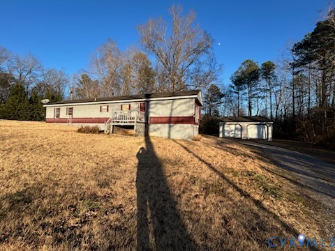 View of front of house with an outdoor structure a