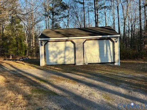 a view of a house with a yard and car parked