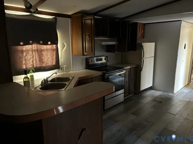 a kitchen with stainless steel appliances a stove a refrigerator and a microwave