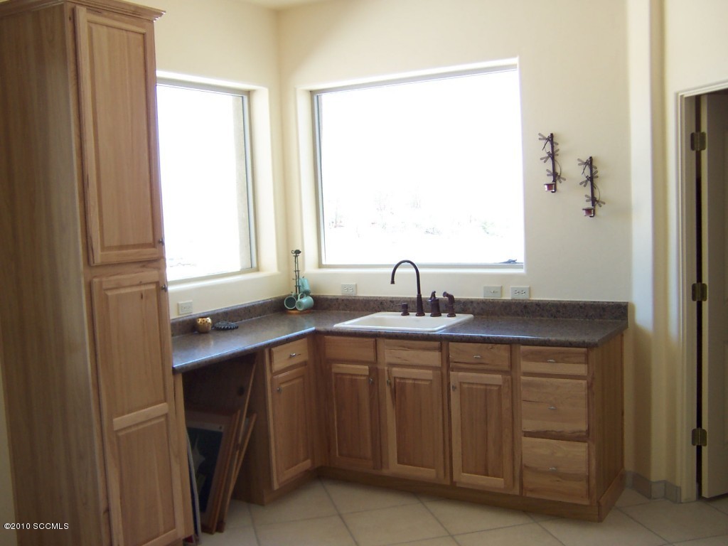 530 Ruth Lane Rio Rico, AZ 85648 - Photo 29 of 36 a kitchen with a sink and cabinets