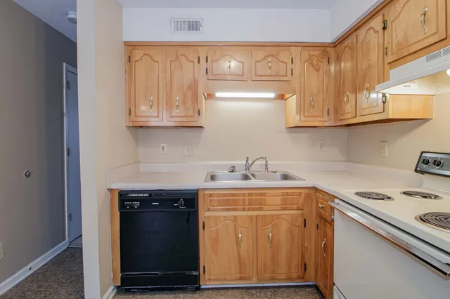 a kitchen with granite countertop cabinets stainless steel appliances and a counter space