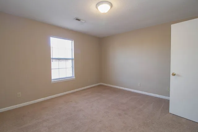 a view of an empty room and closet area