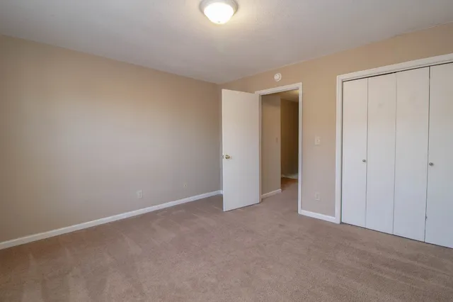 an empty room with closet area