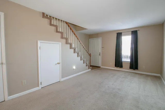 a view of an empty room with stairs