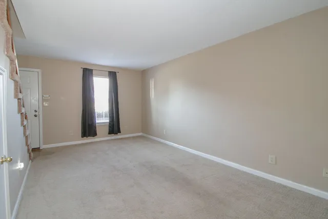 a view of an empty room and a window