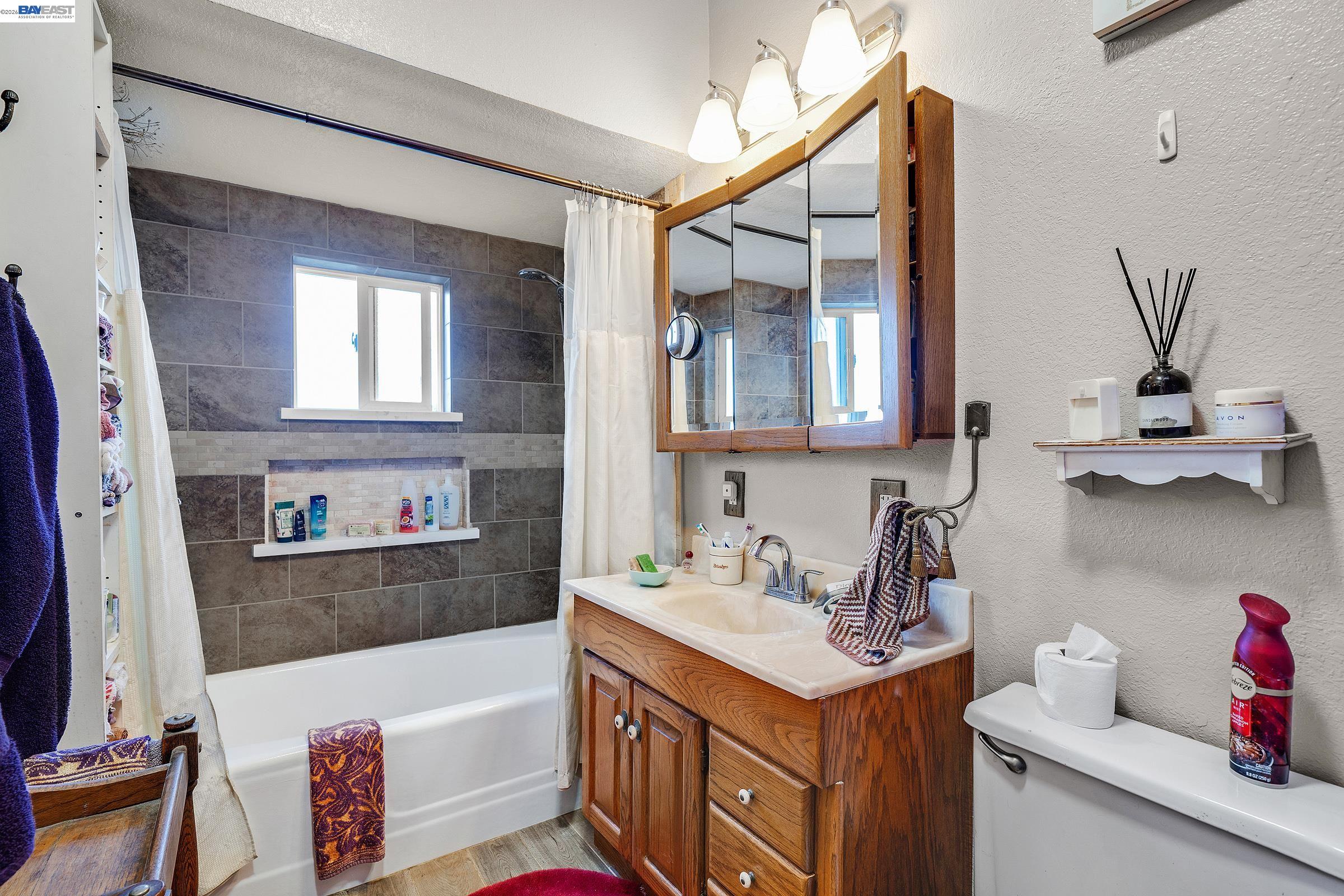 1177 Thiel Road Hayward, CA 94544 - Photo 11 of 55 a bathroom with a sink and a bathtub