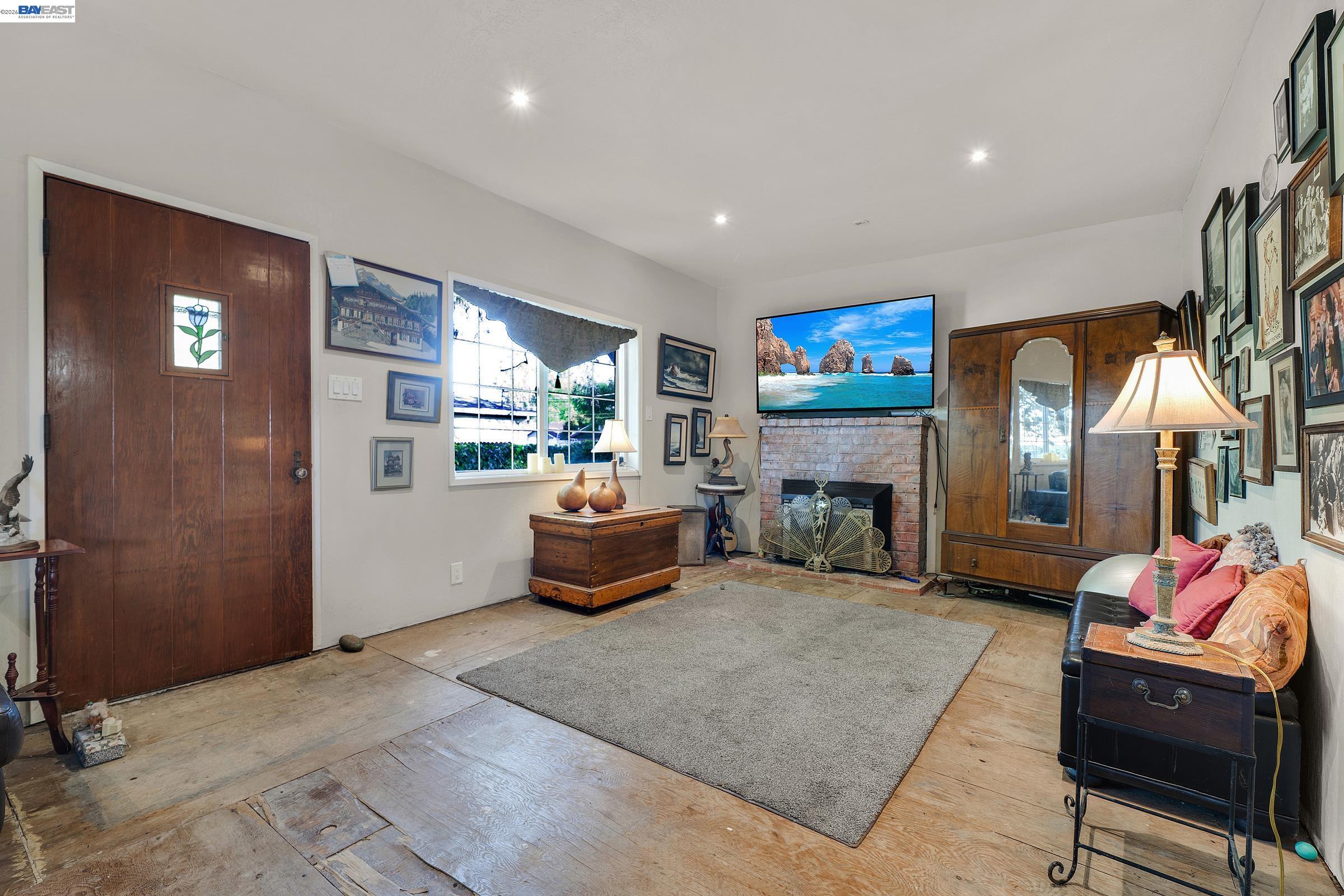1177 Thiel Road Hayward, CA 94544 - Photo 21 of 55 a living room with furniture and a fireplace