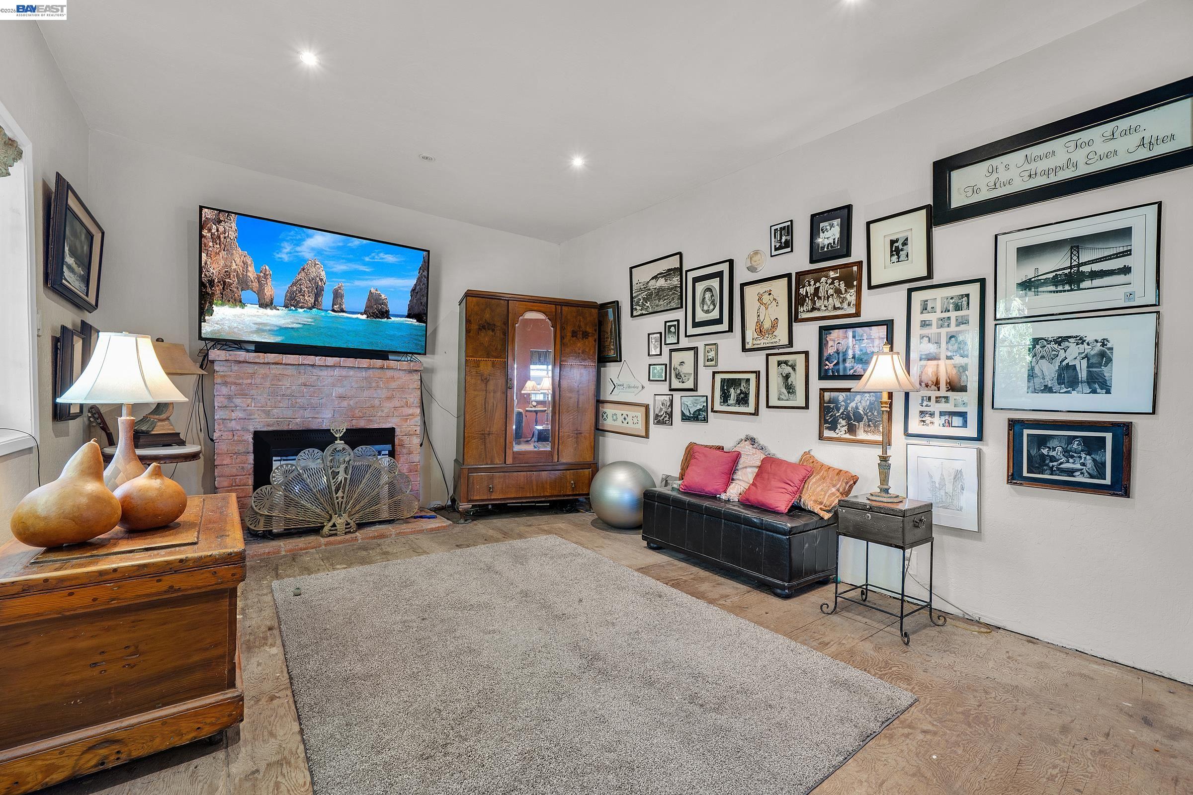 1177 Thiel Road Hayward, CA 94544 - Photo 24 of 55 a living room with furniture and a fireplace