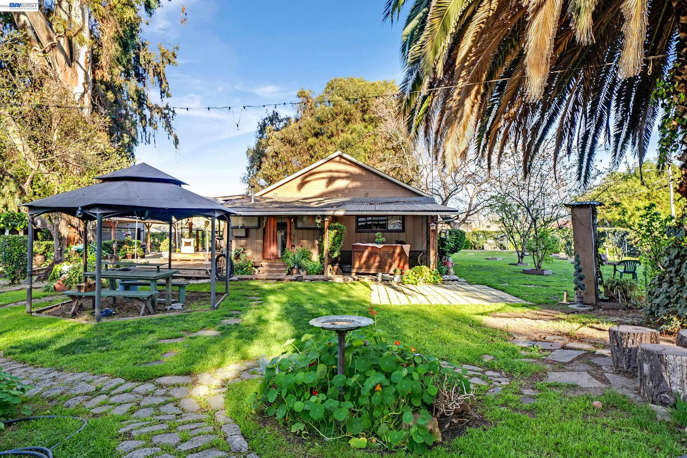 1177 Thiel Road Hayward, CA 94544 - Photo 33 of 55 a front view of a house with a yard table and chairs