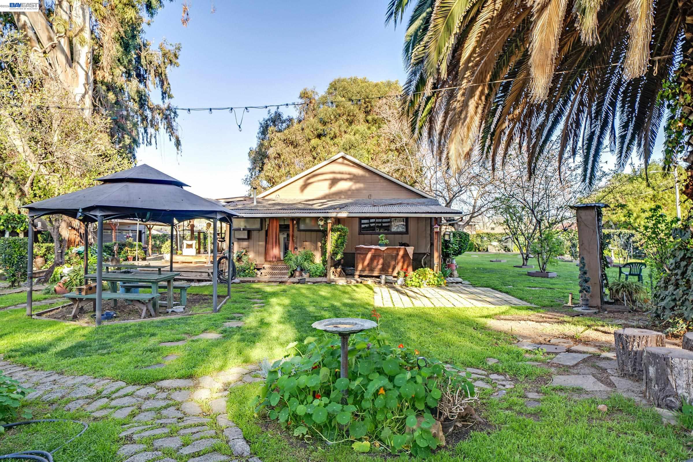 1177 Thiel Road Hayward, CA 94544 - Photo 35 of 55 a front view of a house with a yard table and chairs