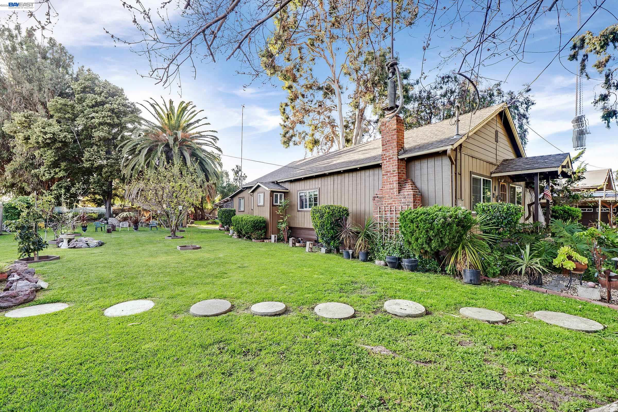 1177 Thiel Road Hayward, CA 94544 - Photo 37 of 55 a view of a white house with a yard and sitting area