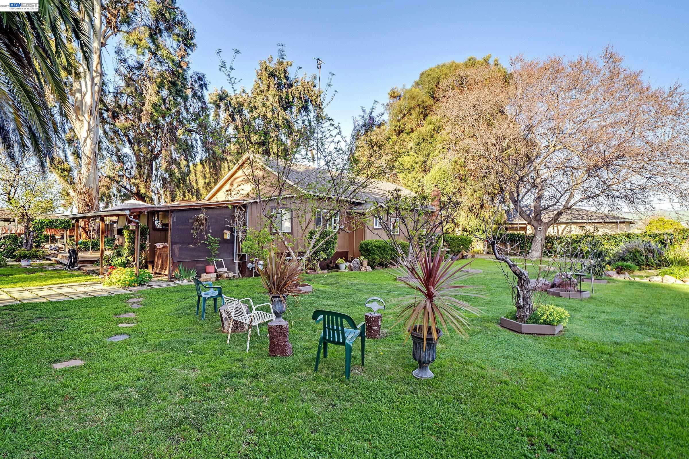 1177 Thiel Road Hayward, CA 94544 - Photo 38 of 55 a view of an house with backyard and a tree