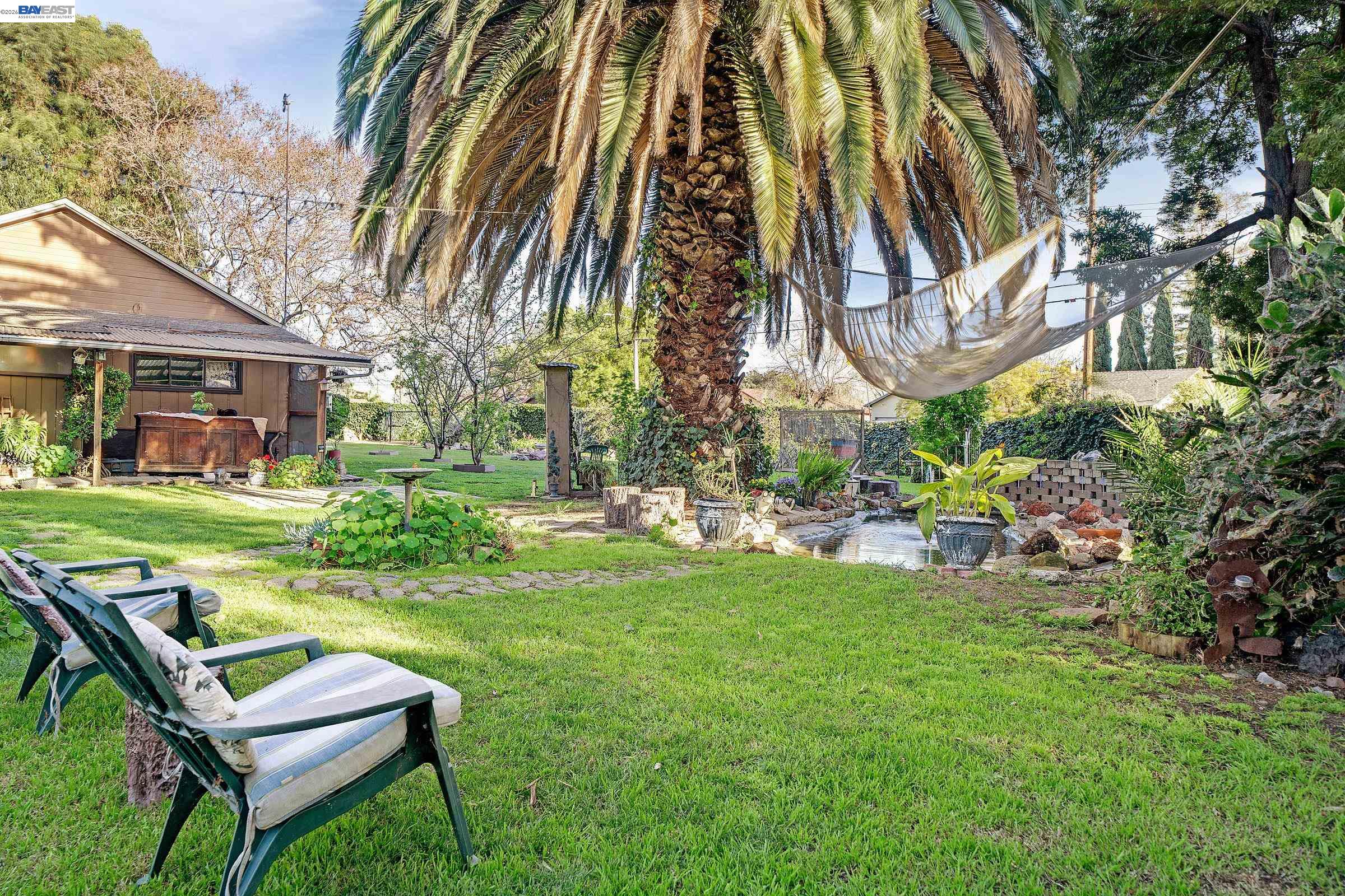 1177 Thiel Road Hayward, CA 94544 - Photo 53 of 55 a view of backyard of house with outdoor seating and green space