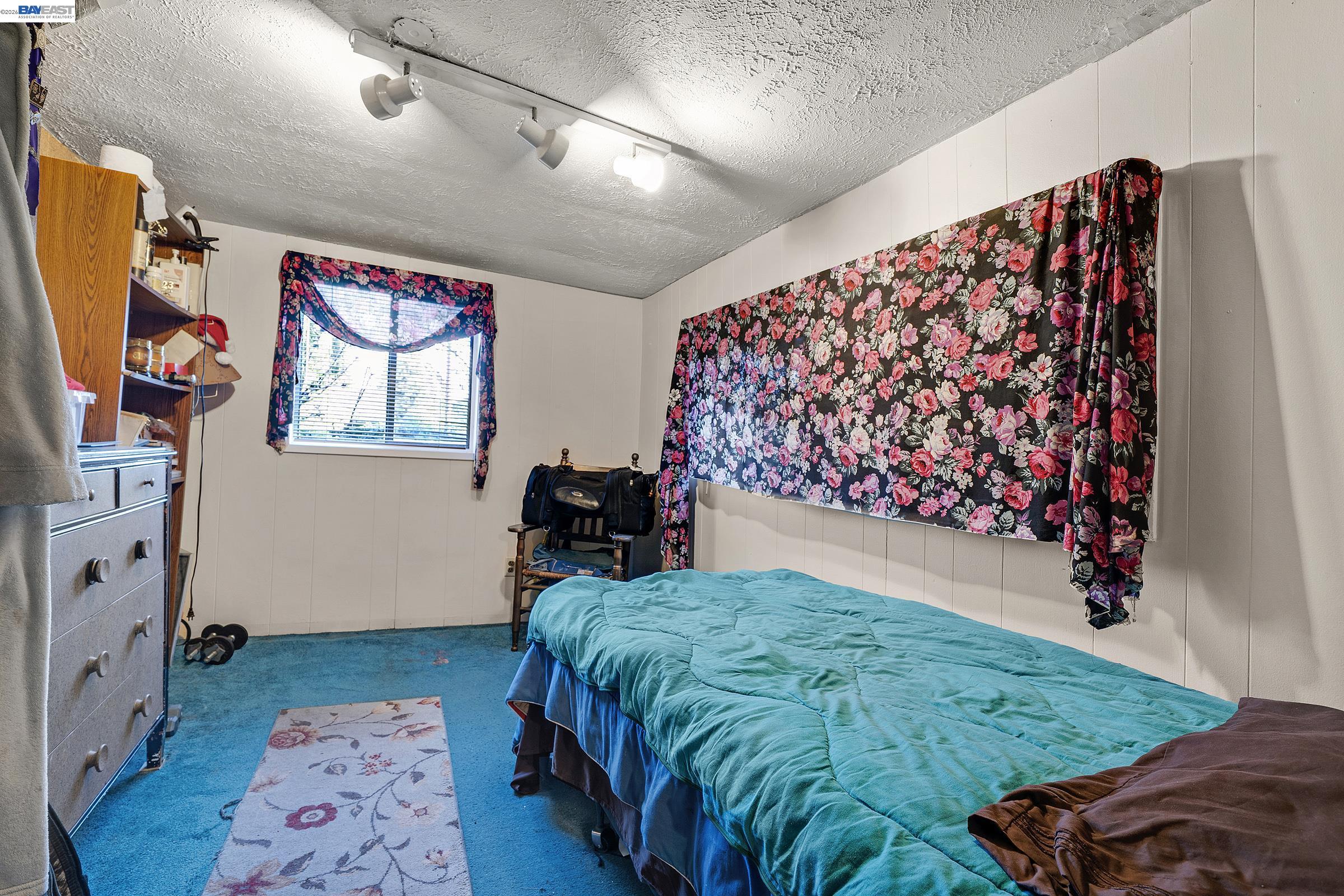 1177 Thiel Road Hayward, CA 94544 - Photo 9 of 55 a bed sitting in a room next to a window