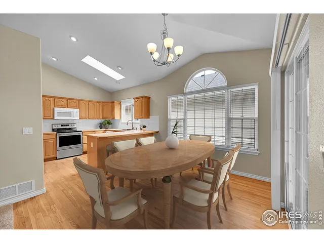 a view of kitchen with stainless steel appliances granite countertop a sink a stove and a refrigerator
