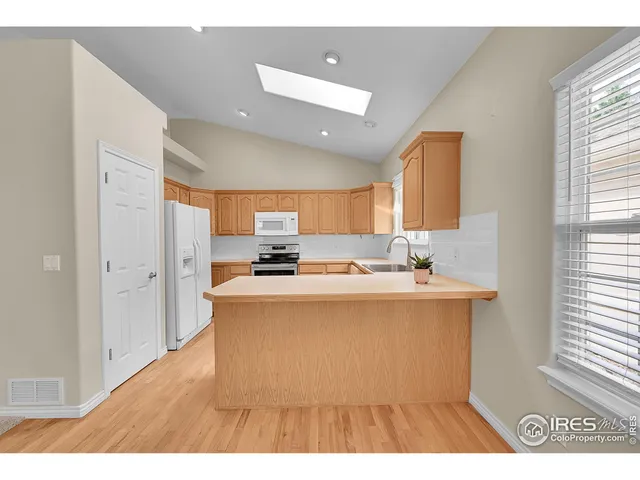 a kitchen with granite countertop a stove top oven sink and cabinets