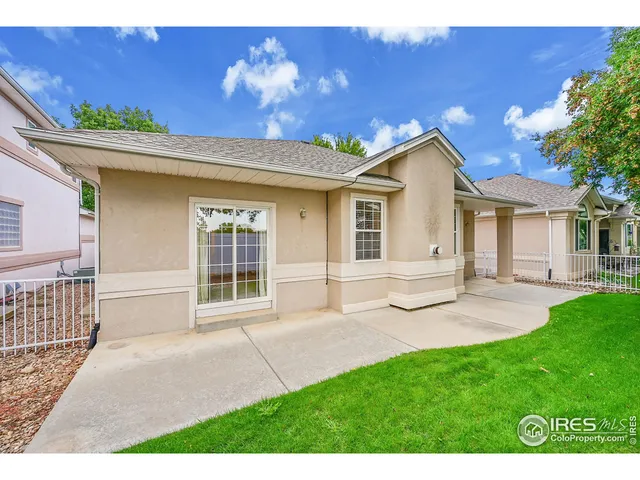 a view of a house with a yard and potted plants