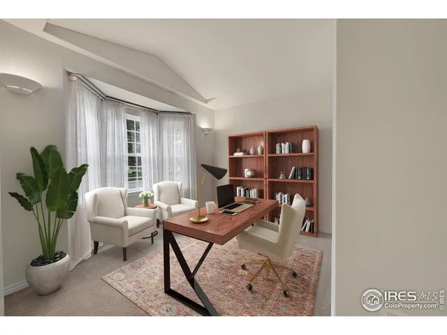 a living room with furniture a bookshelf and a potted plant