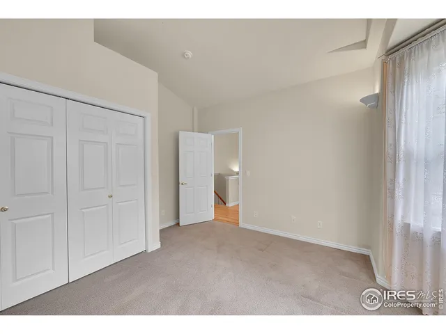 a living room with furniture a fireplace and a large window