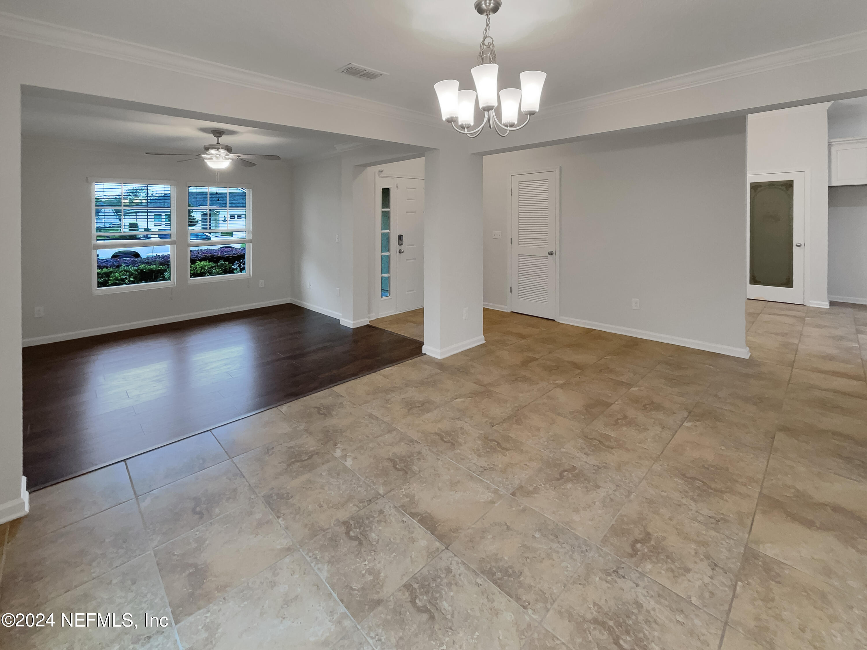 204 Providence Drive St. Augustine, FL 32092 - Photo 9 of 20 a view of a livingroom with a chandelier fan and windows