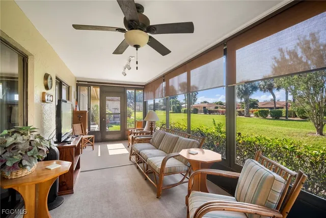 a living room with patio furniture and garden