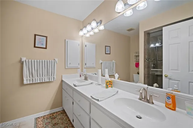 a bathroom with a sink double vanity and a mirror