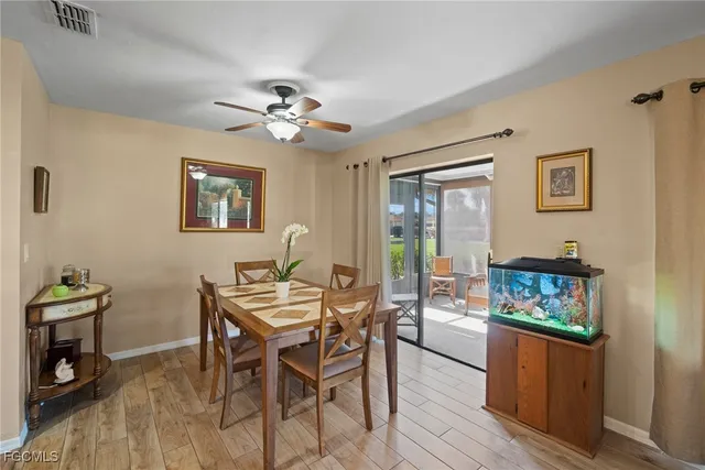 a view of a dining room with furniture a chandelier and wooden floor