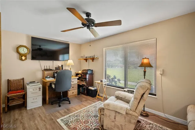 a view of a workspace with furniture and a window