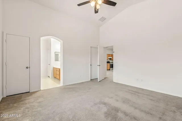 a large kitchen with cabinets wooden floor and stainless steel appliances