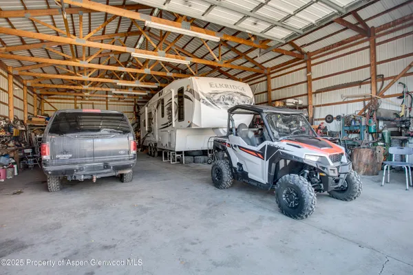 a view of parking garage with cars parked