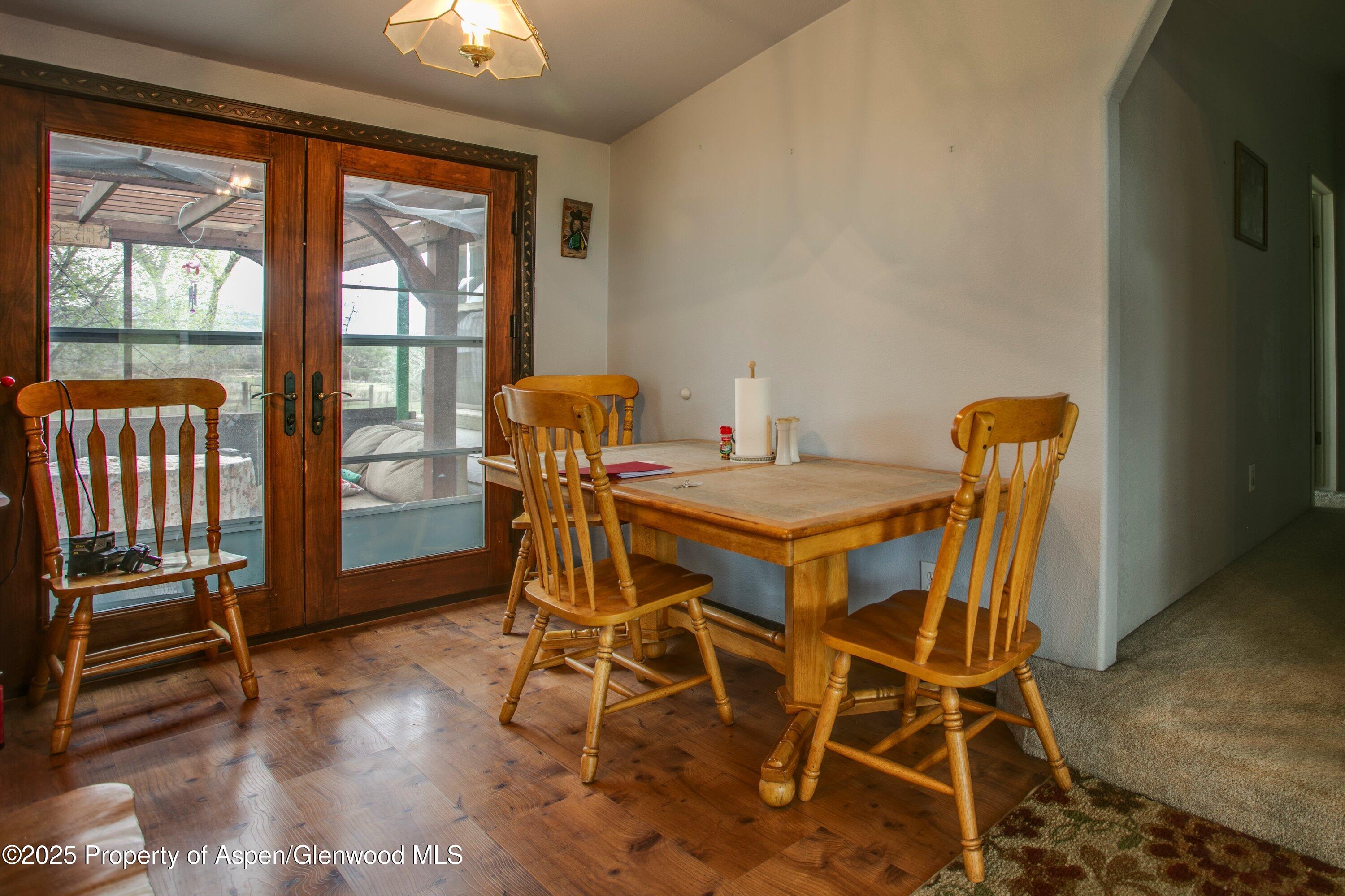 70 Frontage Road De Beque, CO 81630 - Photo 19 of 26 a view of a dining room with furniture and wooden floor