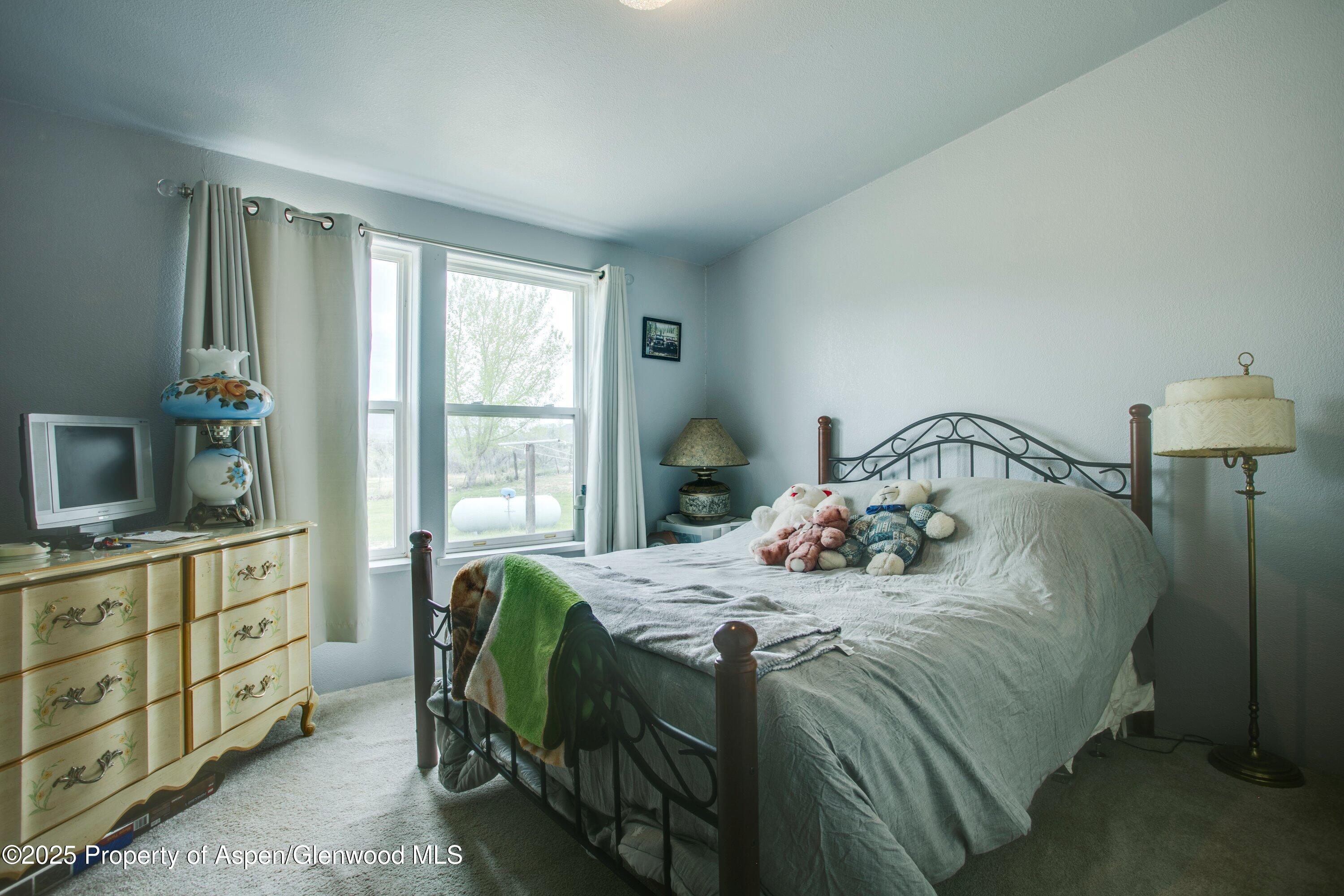 70 Frontage Road De Beque, CO 81630 - Photo 24 of 26 a bedroom with a bed and a dresser in it