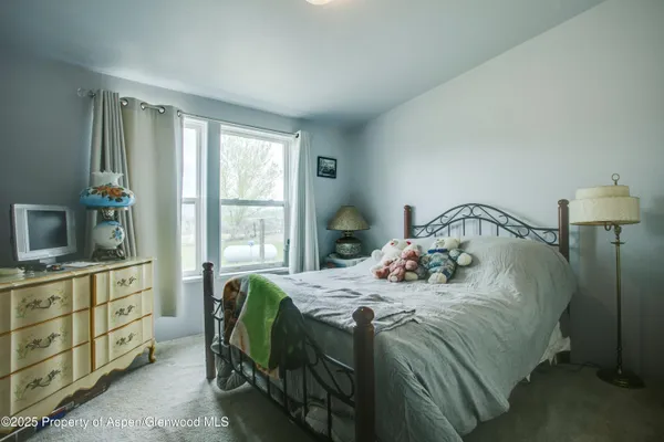 a bedroom with a bed and a dresser in it